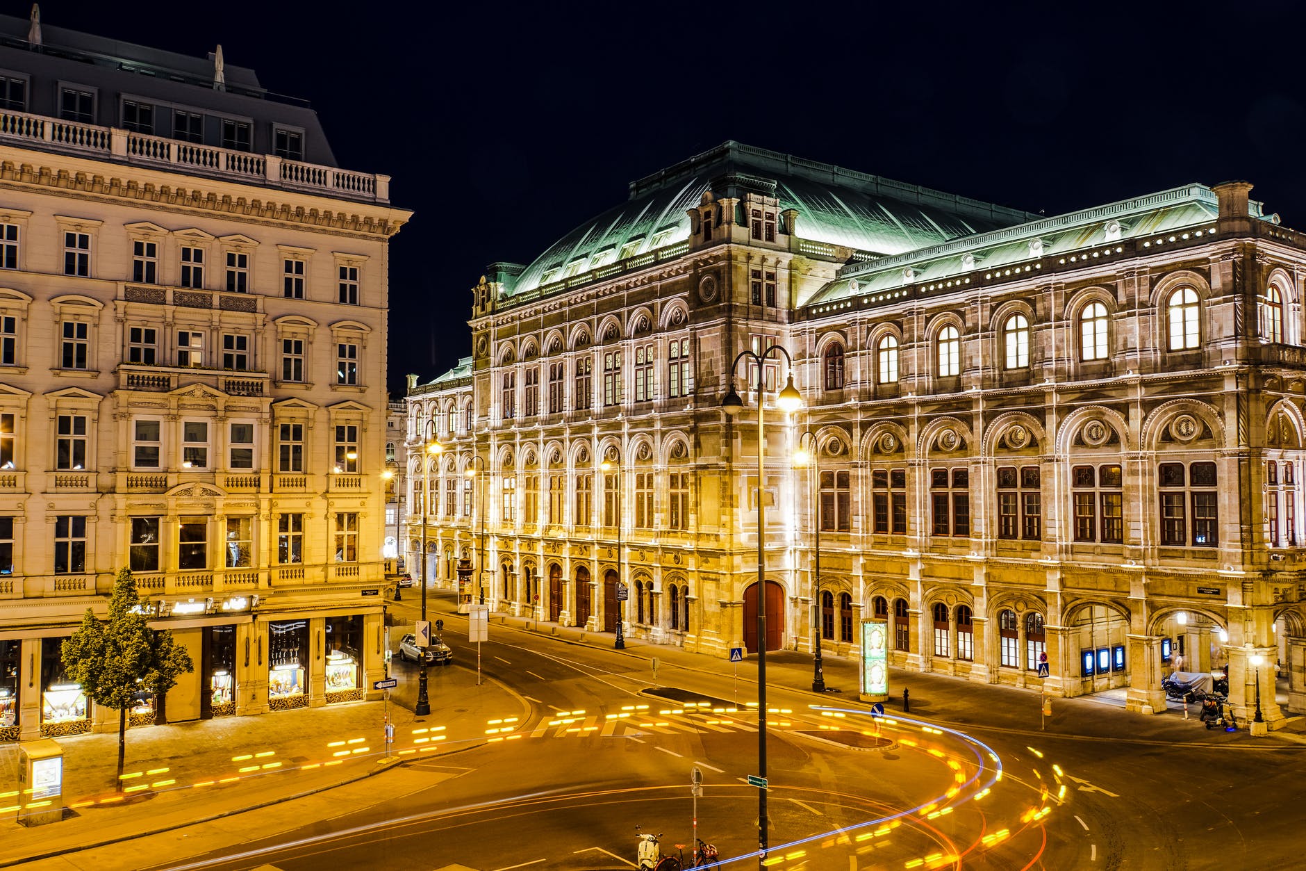 time lapse photography of cars on road near building during night time